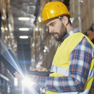 Warehouse manager reviewing fleet performance data from fleet insights